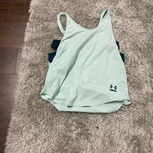 Teal under armour workout top. Open on the sides with stripes of dark blue.